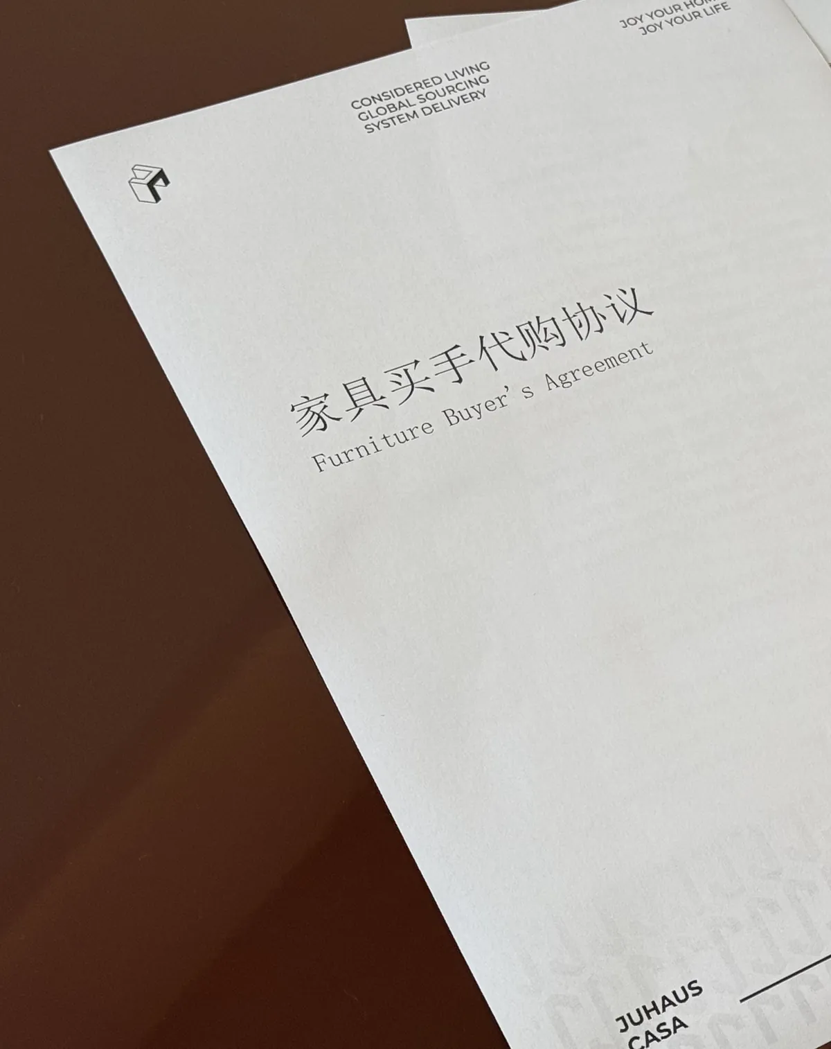 The cover of a furniture buyer agreement, photographed on a table.