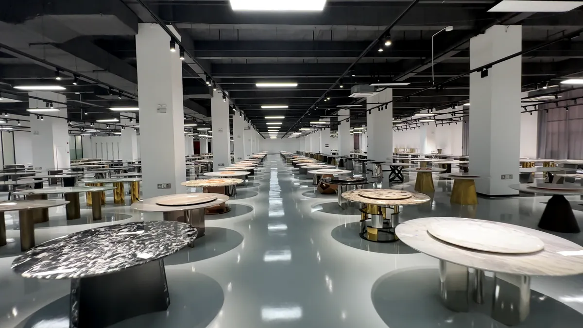 Rows of natural stone slabs and sample tables.