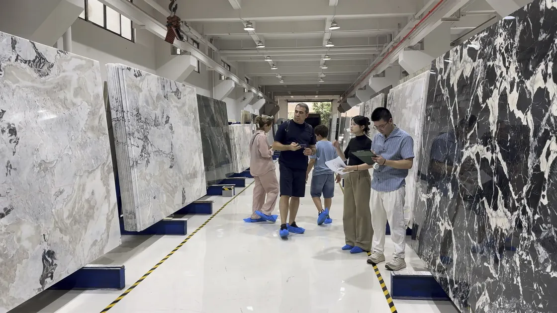A group stands between tall stone slabs while one adult holds a clipboard and another holds printed references.